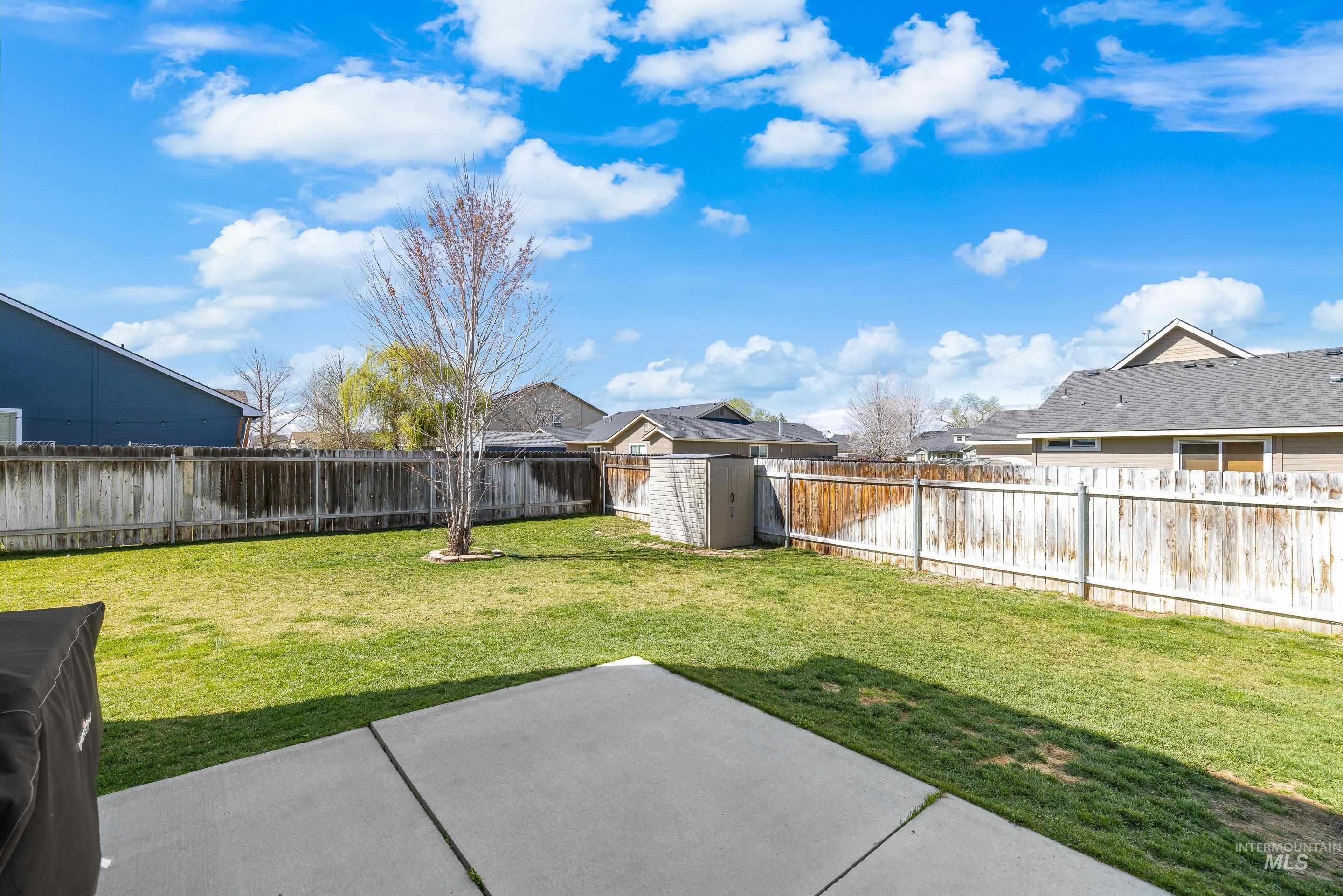 700 Southwest Panner Street Mountain Home, ID 83647 - Photo 46 of 50 Fenced backyard featuring a shed, a residential view, and a patio area
