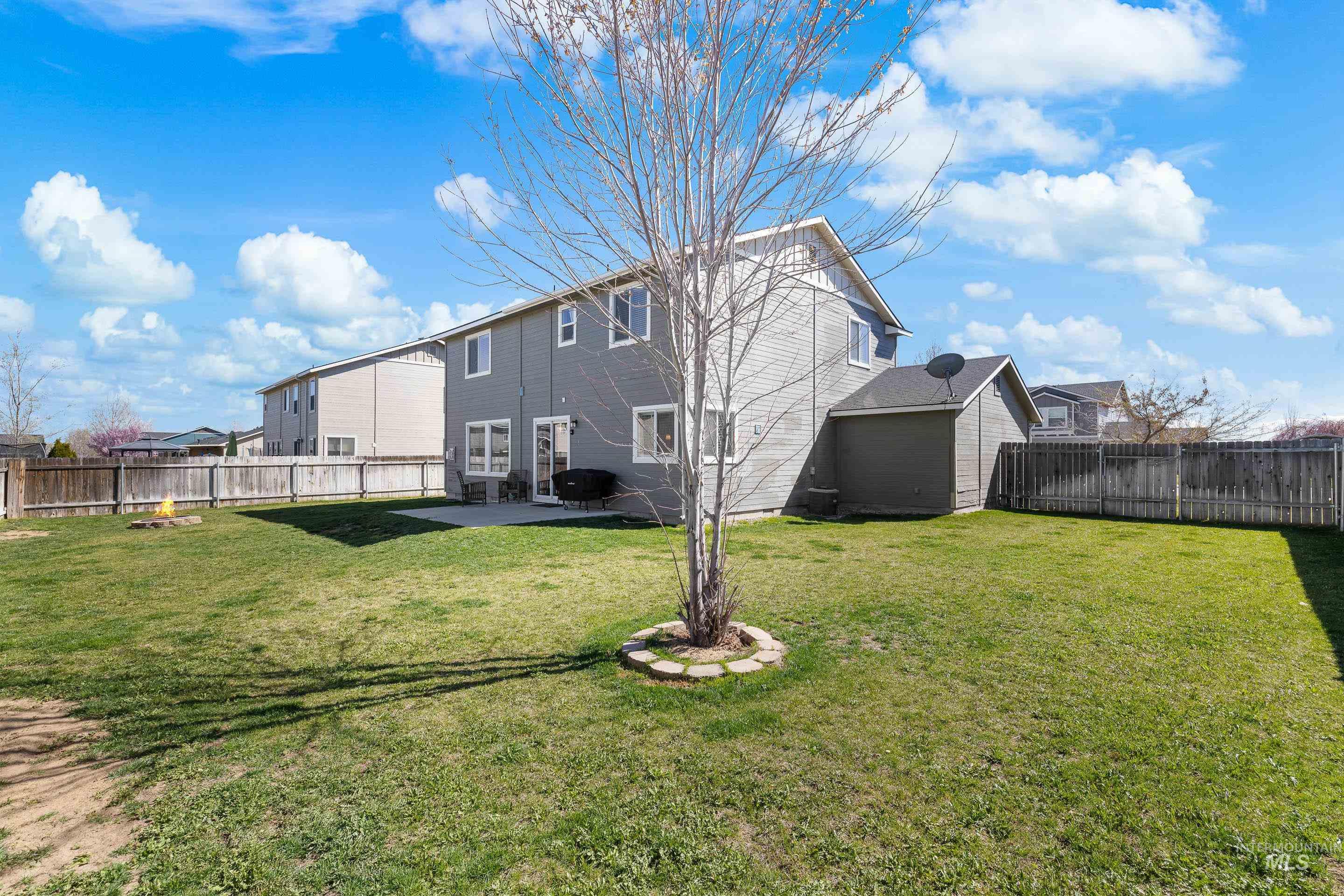 700 Southwest Panner Street Mountain Home, ID 83647 - Photo 48 of 50 Rear view of house featuring a fenced backyard and a patio area