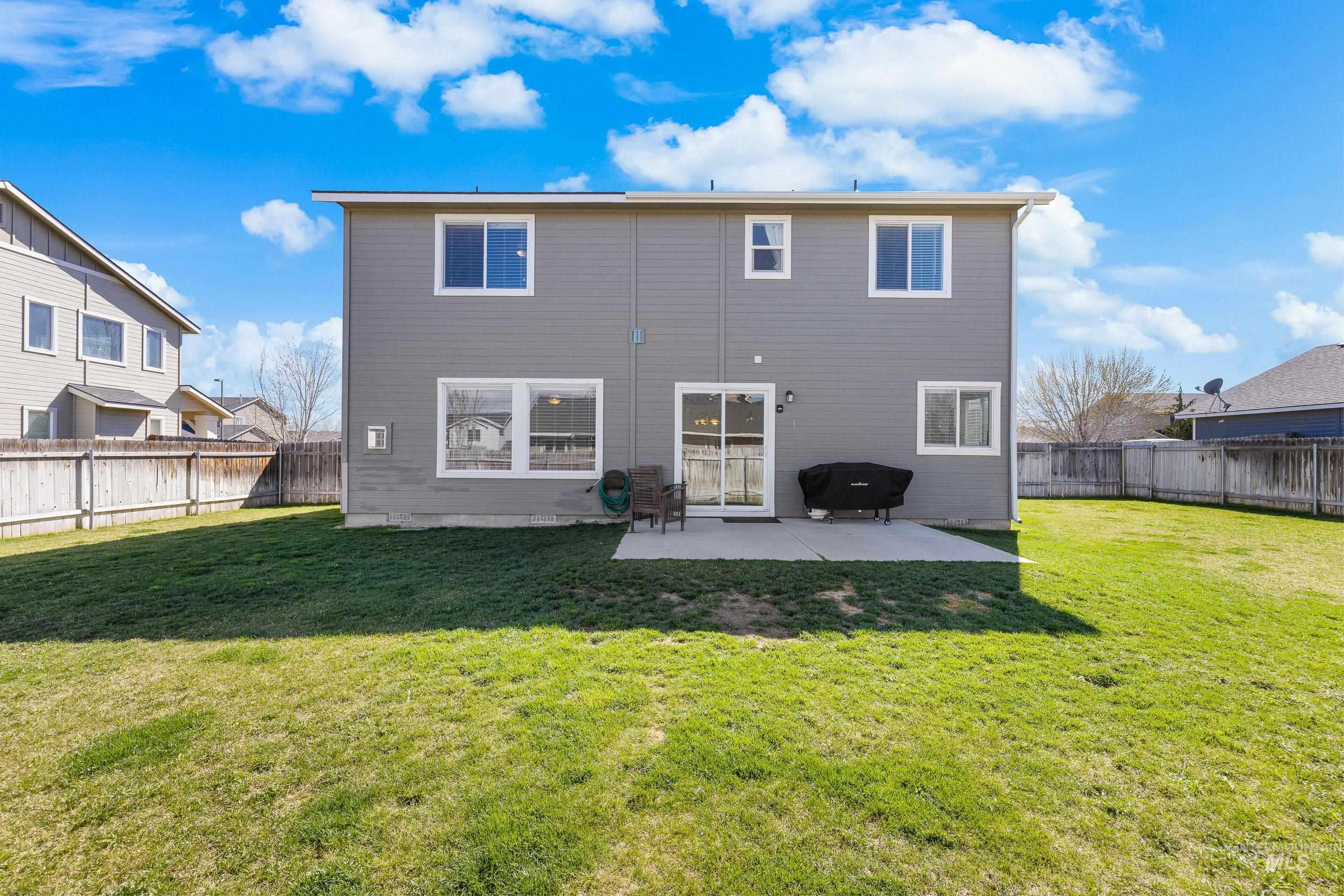 700 Southwest Panner Street Mountain Home, ID 83647 - Photo 49 of 50 Rear view of house featuring a patio area and a fenced backyard