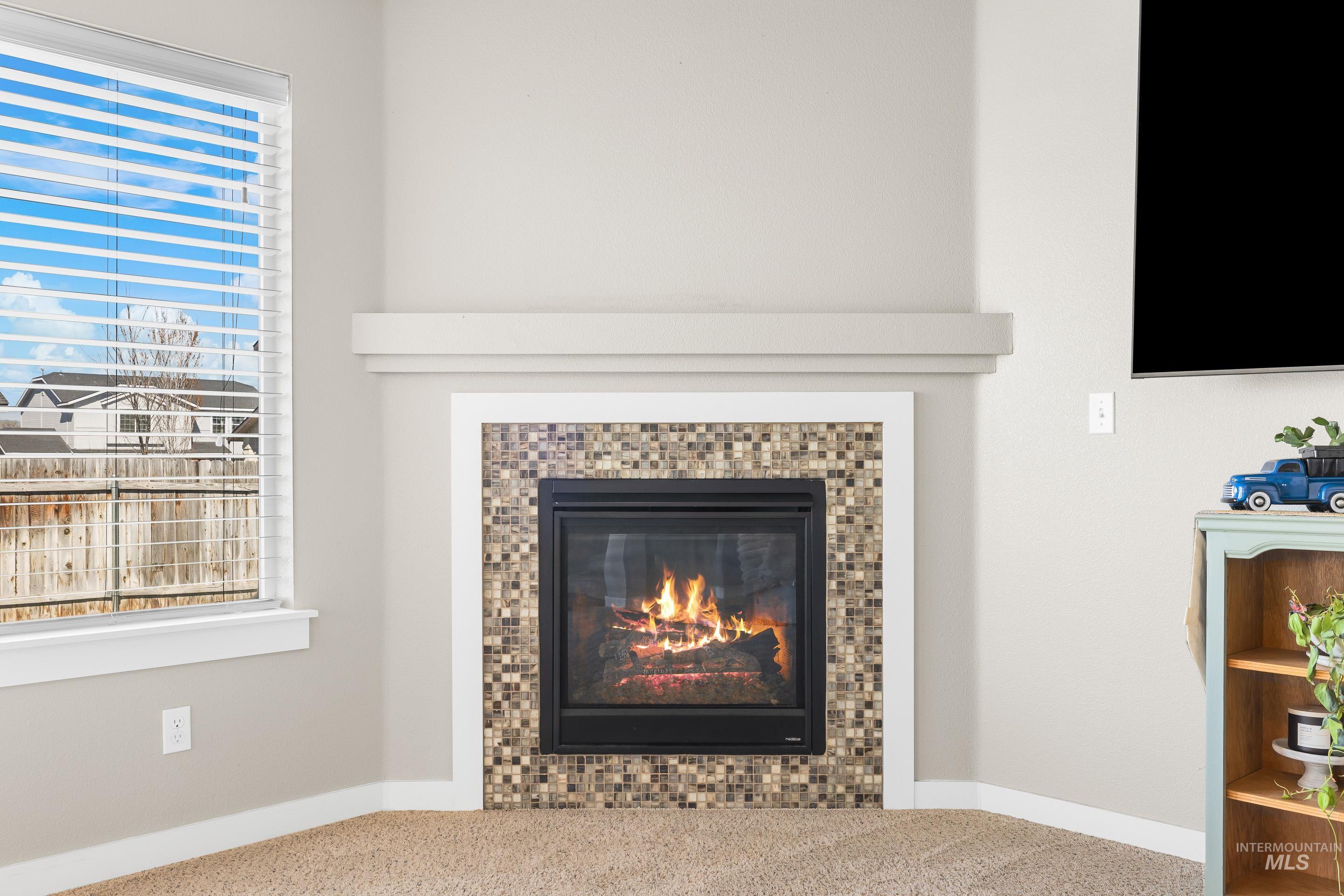 700 Southwest Panner Street Mountain Home, ID 83647 - Photo 9 of 50 Detailed view of carpet flooring and a tiled fireplace