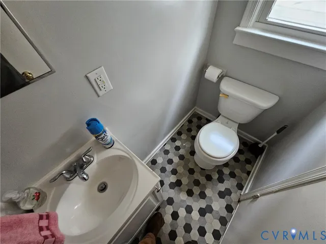 a bathroom with a sink toilet and a mirror