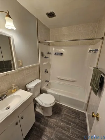 a bathroom with a double vanity sink toilet mirror and shower