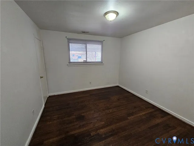 an empty room with wooden floor