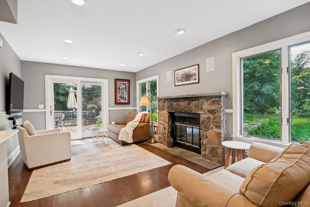 312 Quaker Road Chappaqua, NY 10514 - Photo 13 of 36 a living room with furniture large window and a fireplace