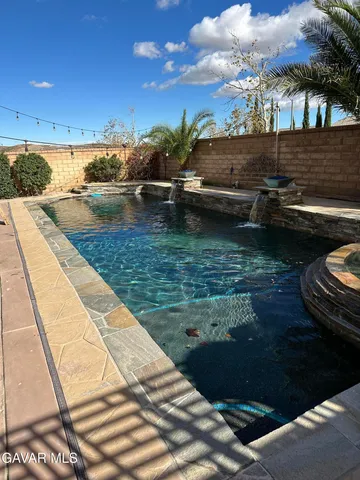 a view of swimming pool with a patio