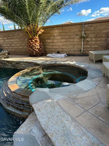 a view of backyard with swimming pool