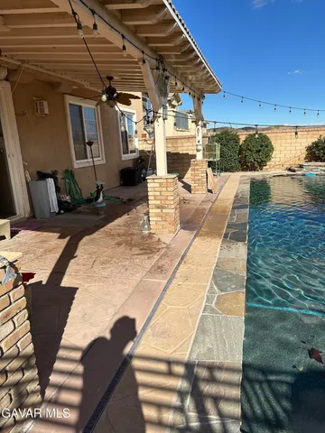 a view of a backyard with sitting area