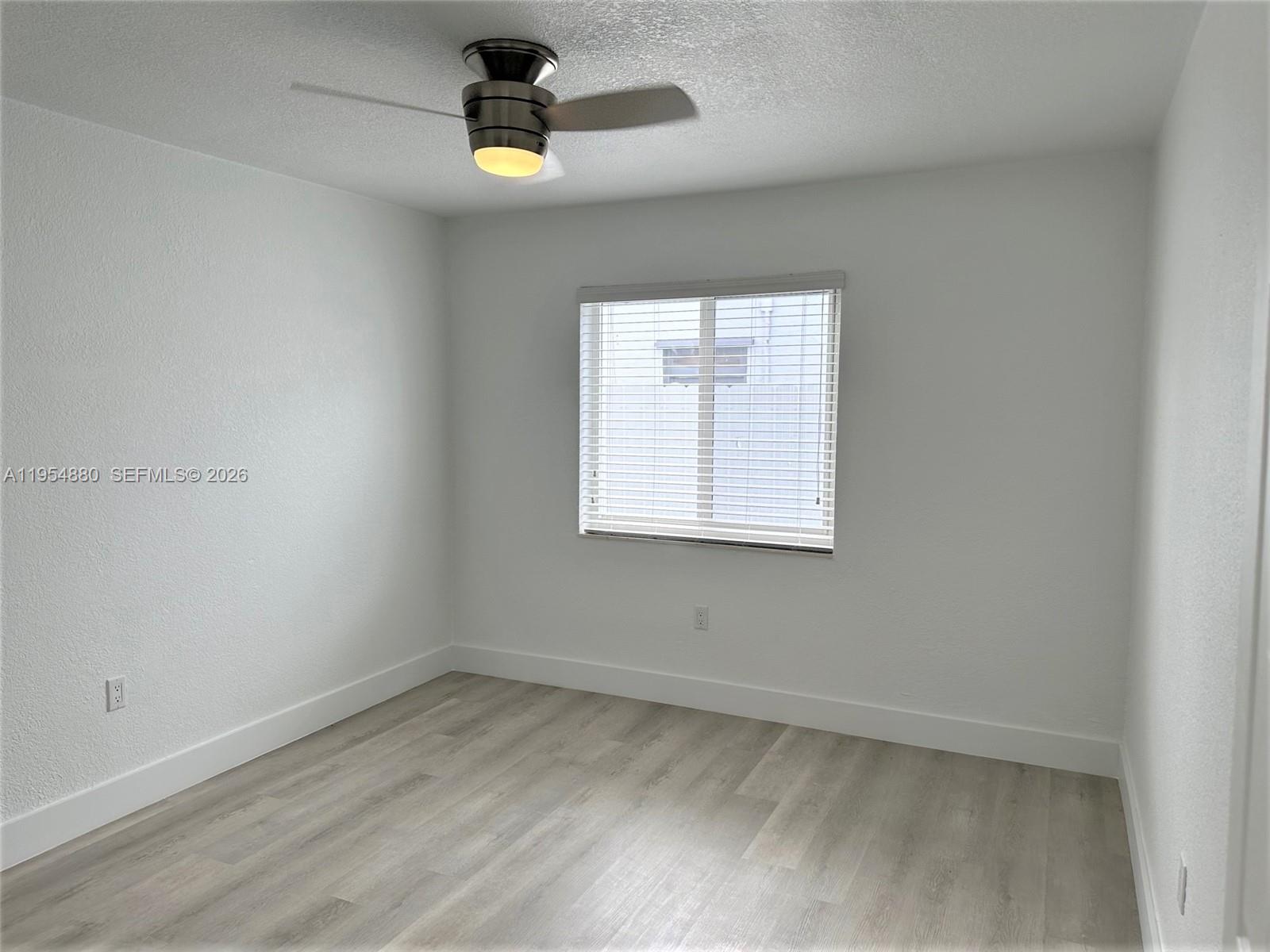 11230 Southwest 5th Street, Unit 1 Sweetwater, FL 33174 - Photo 15 of 25 an empty room with a window