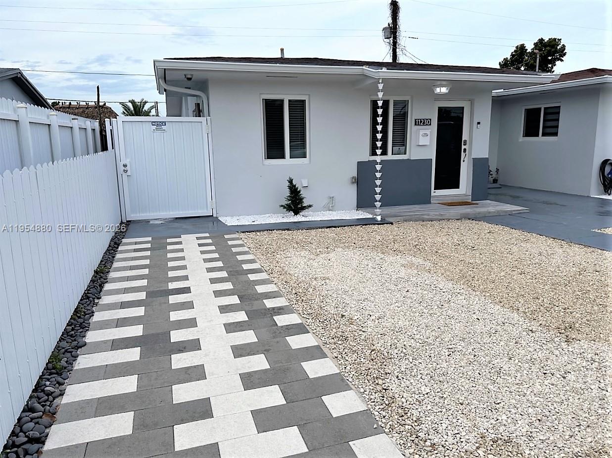 11230 Southwest 5th Street, Unit 1 Sweetwater, FL 33174 - Photo 20 of 25 a front view of a house with a checkered floor