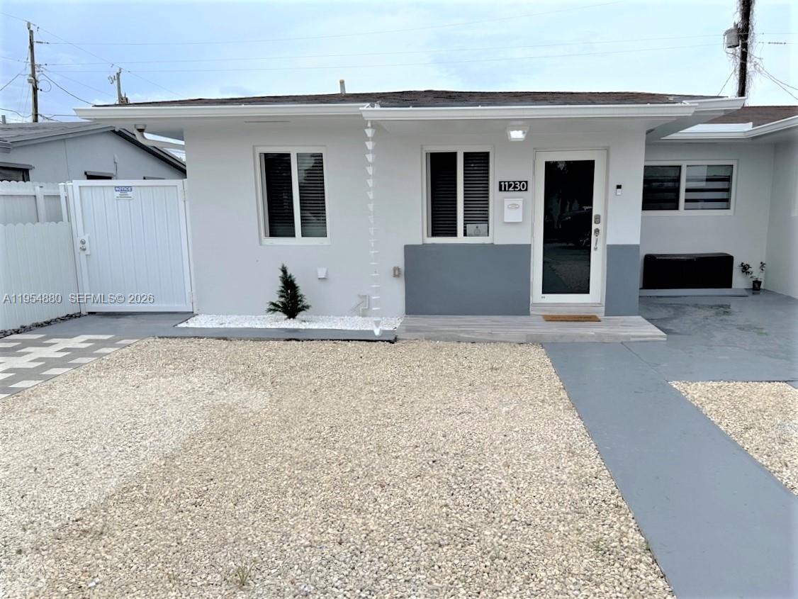 11230 Southwest 5th Street, Unit 1 Sweetwater, FL 33174 - Photo 2 of 25 a living room with granite countertop couches and rug