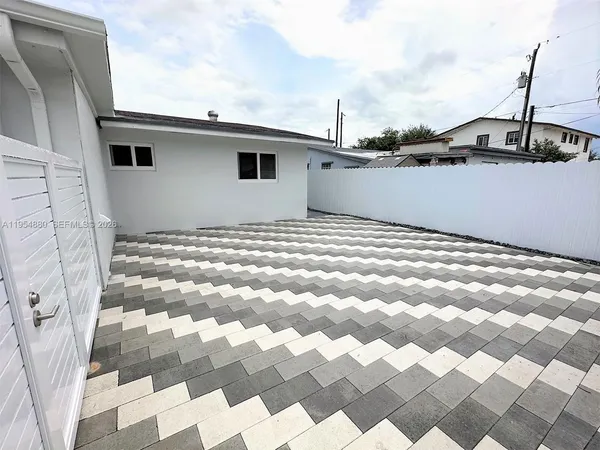 a view of a house with wooden fence