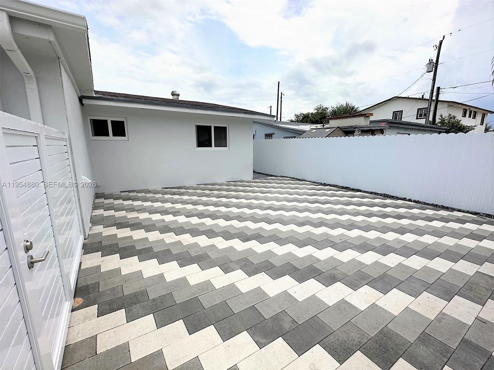11230 Southwest 5th Street, Unit 1 Sweetwater, FL 33174 - Photo 24 of 25 a view of a house with wooden fence