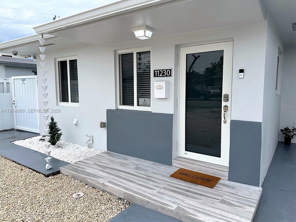 11230 Southwest 5th Street, Unit 1 Sweetwater, FL 33174 - Photo 3 of 25 a bedroom with a bed and a window