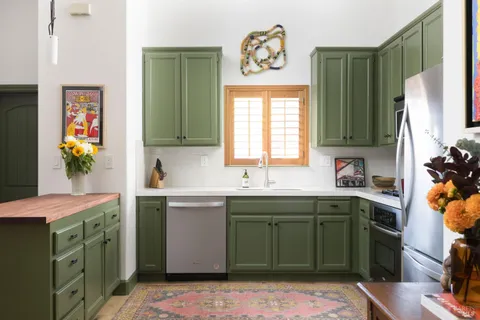 a kitchen with a sink cabinets and appliances