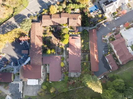 an aerial view of residential houses with outdoor space and street view