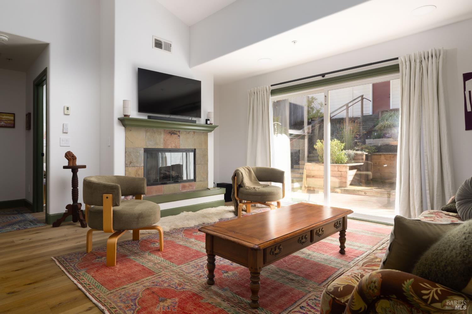 14632 Jomark Lane Occidental, CA 95465 - Photo 3 of 29 a living room with furniture a flat screen tv and a fireplace