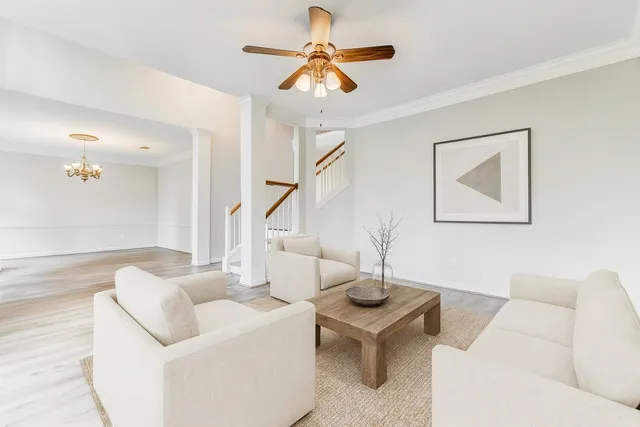 a living room with furniture and a chandelier