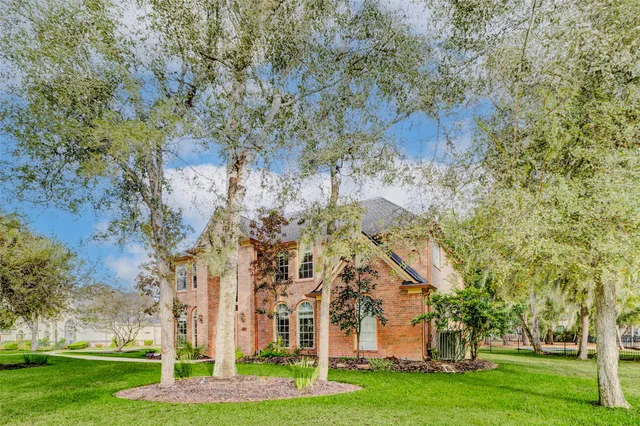 a garden with trees in front of it