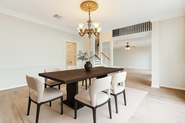 a view of a dining room with furniture and chandelier