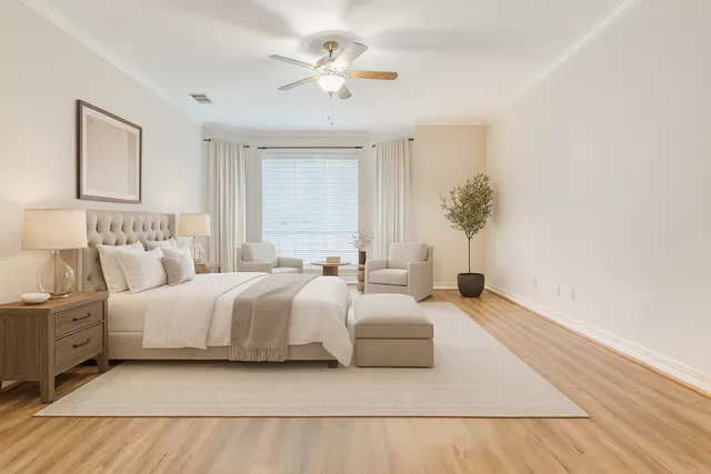 a spacious bedroom with a bed and a chandelier