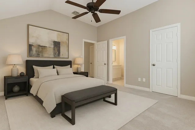 a spacious bedroom with a bed and painting on the wall