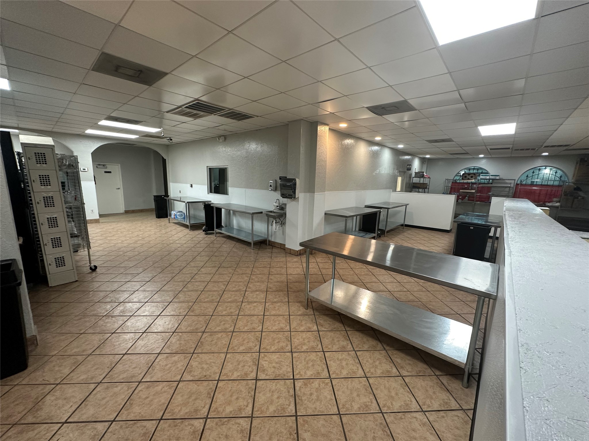 7820 Fulton Street Houston, TX 77022 - Photo 13 of 23 a large room with lots of furniture and a large window