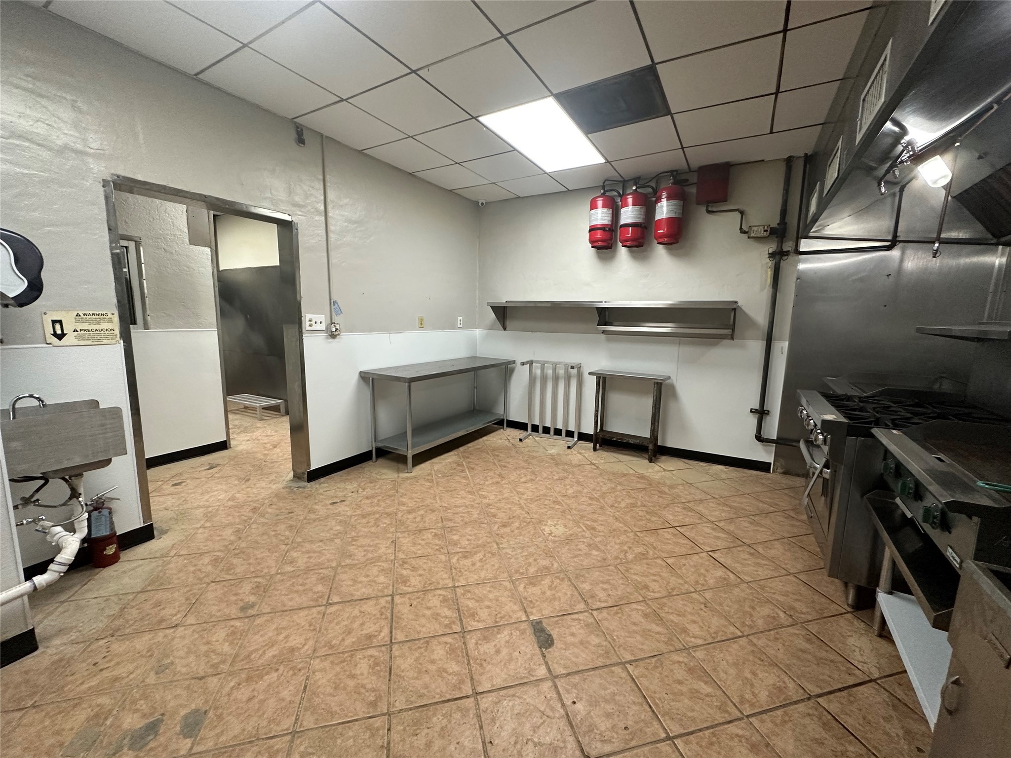 7820 Fulton Street Houston, TX 77022 - Photo 19 of 23 a kitchen with granite countertop a stove a sink and a refrigerator