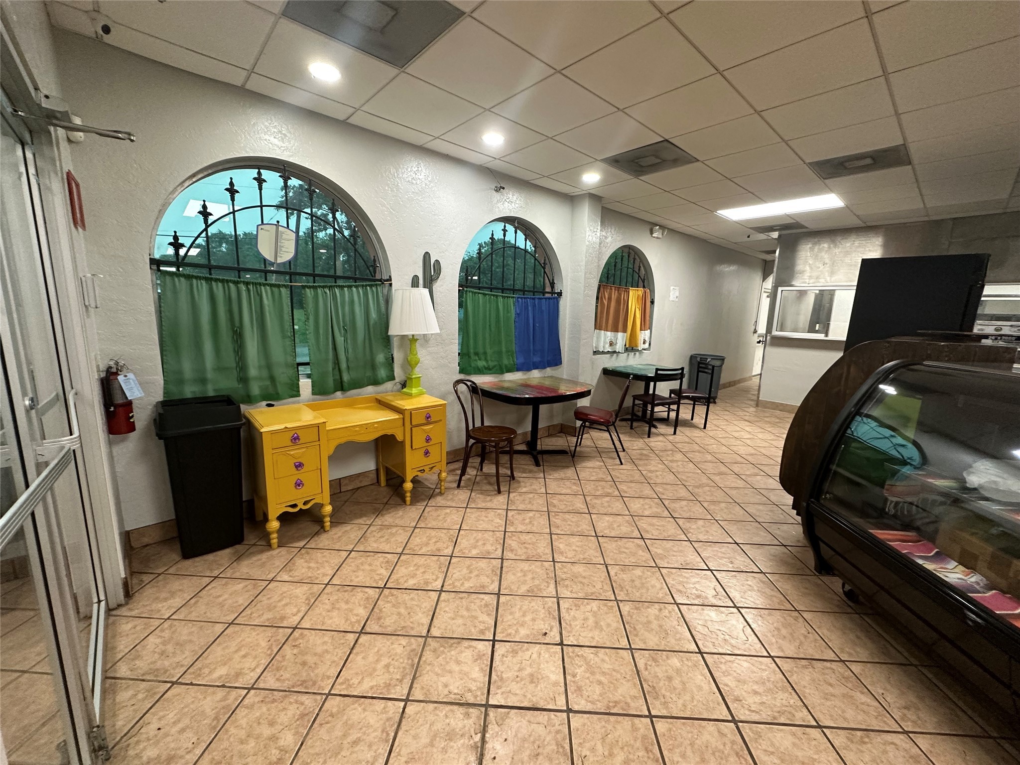 7820 Fulton Street Houston, TX 77022 - Photo 5 of 23 a living room with furniture a fireplace and a chandelier