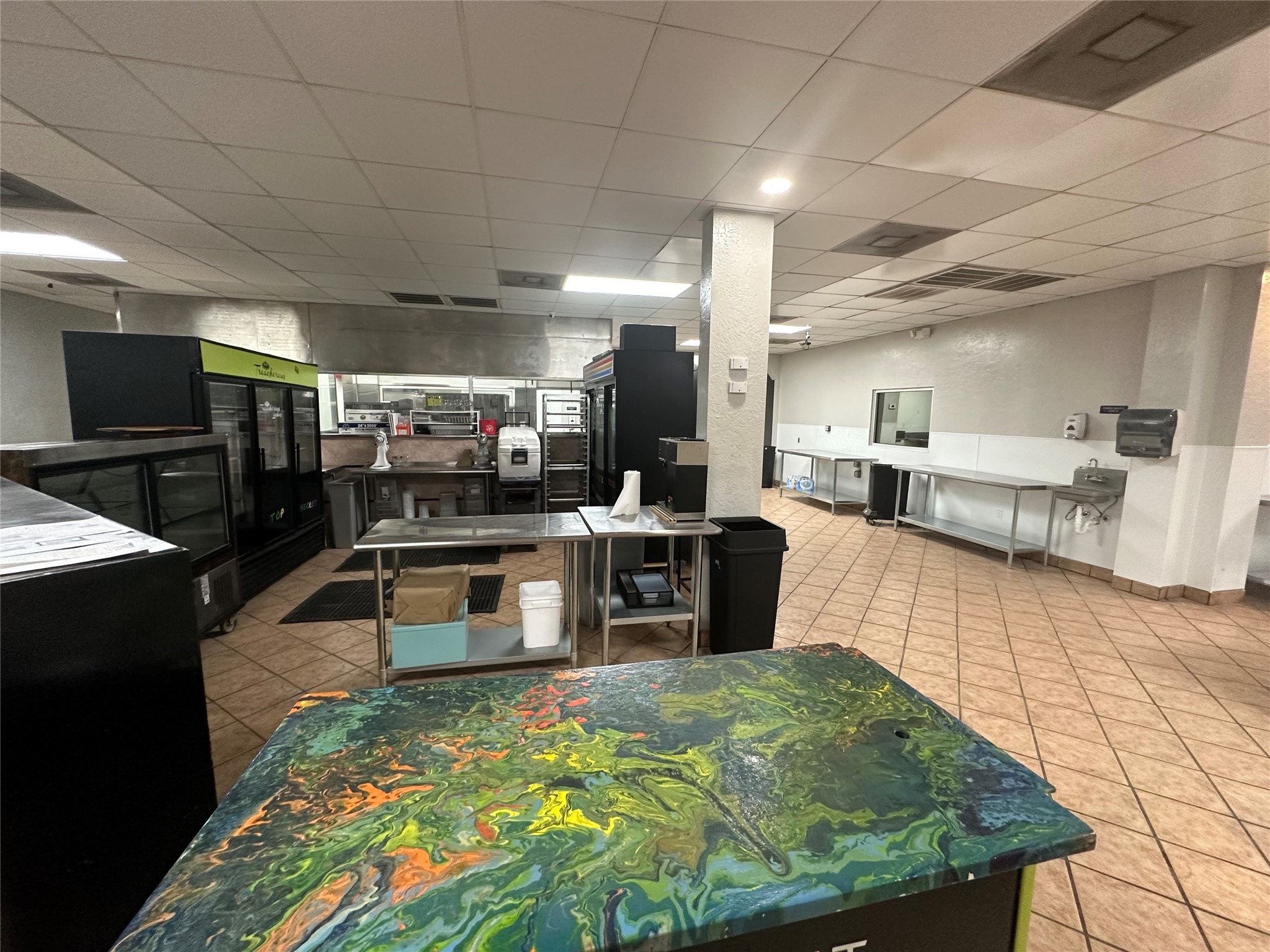 7820 Fulton Street Houston, TX 77022 - Photo 9 of 23 a large kitchen with kitchen island a counter top space a sink and stainless steel appliances