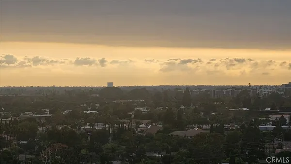 a view of a city with lush green forest