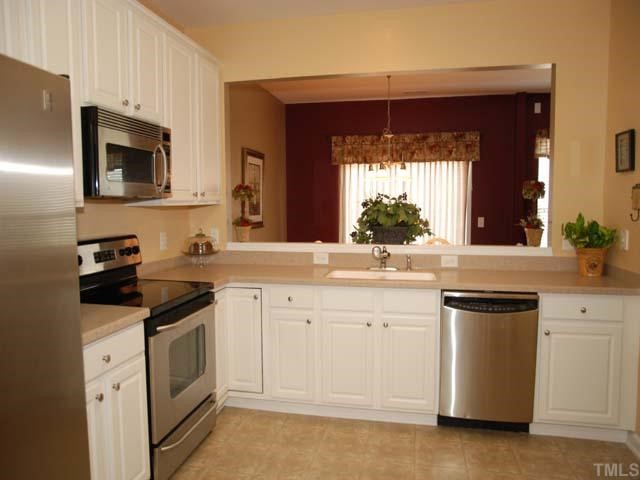 7824 Jeffrey Alan Court Raleigh, NC 27613 - Photo 3 of 11 a kitchen with a sink stove and microwave