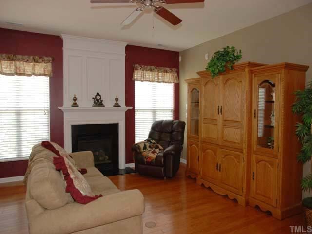 7824 Jeffrey Alan Court Raleigh, NC 27613 - Photo 4 of 11 a living room with furniture and a fireplace
