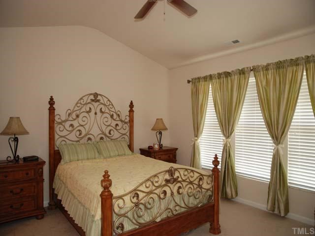 7824 Jeffrey Alan Court Raleigh, NC 27613 - Photo 8 of 11 a bedroom with a bed and a window