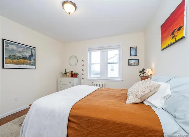 a bedroom with a bed and a window