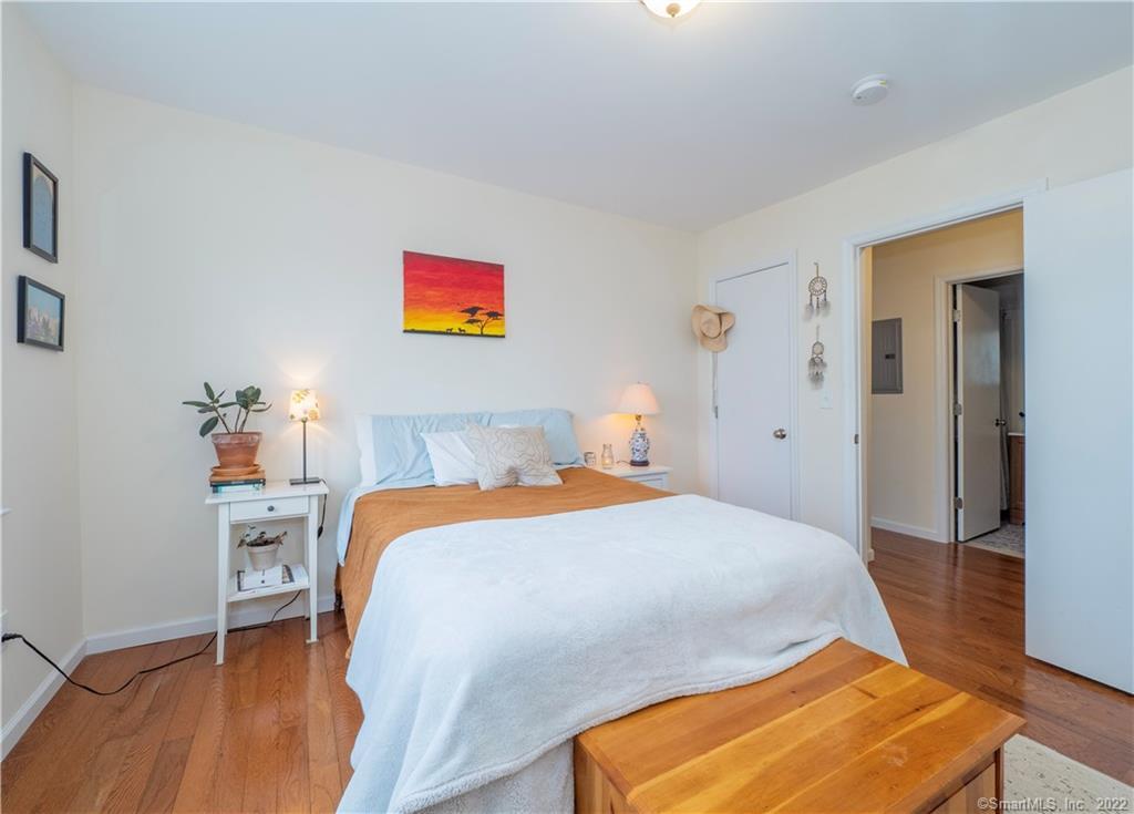 115 Main Street, Unit 5 Norwalk, CT 06851 - Photo 20 of 23 a bedroom with a bed and wooden floor