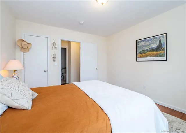 a bedroom with a bed and lamp