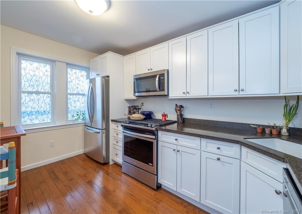 115 Main Street, Unit 5 Norwalk, CT 06851 - Photo 4 of 23 a kitchen with stainless steel appliances granite countertop a stove a sink and white cabinets
