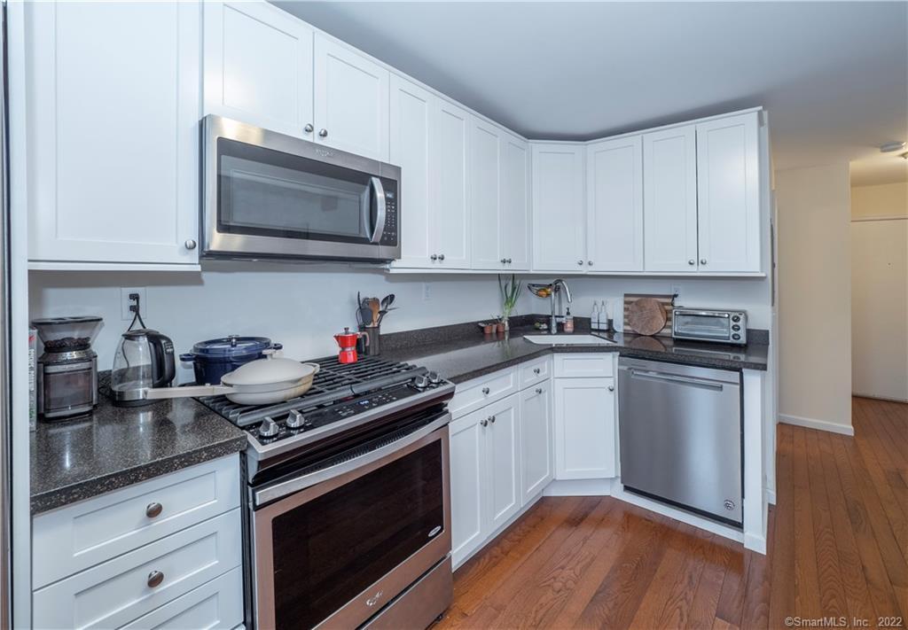 115 Main Street, Unit 5 Norwalk, CT 06851 - Photo 8 of 23 a kitchen with stainless steel appliances granite countertop a stove a sink dishwasher and a microwave oven with cabinets