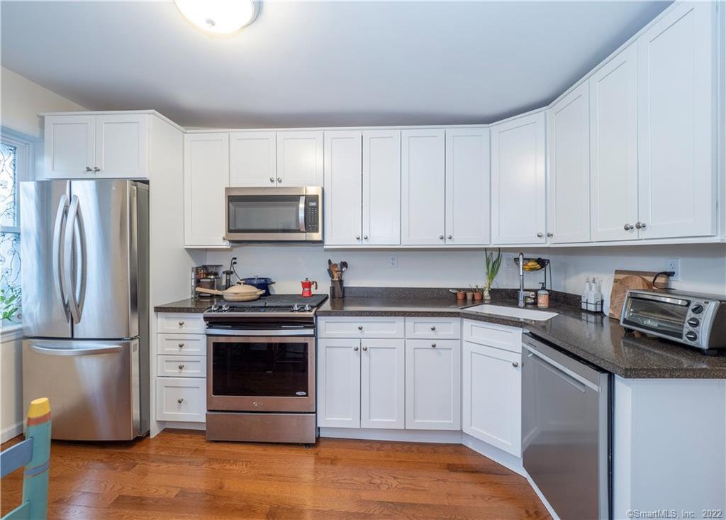 115 Main Street, Unit 5 Norwalk, CT 06851 - Photo 9 of 23 a kitchen with stainless steel appliances granite countertop a stove a refrigerator and a sink