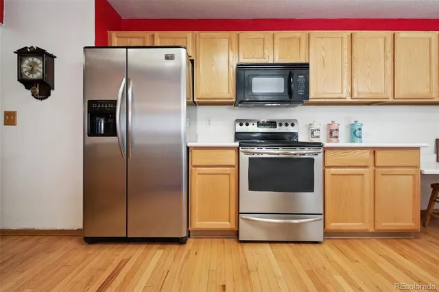a kitchen with stainless steel appliances a refrigerator a stove a microwave and cabinets