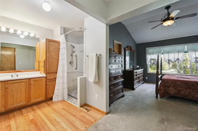 a spacious bedroom with a bed and a chandelier