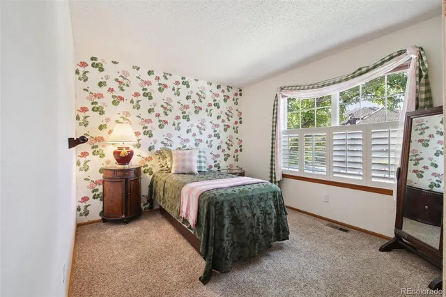 a bed room with a bed and a window