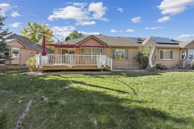 a view of a house with a yard and a garden