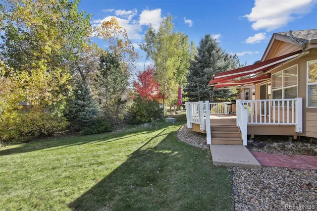 a view of a house with backyard and sitting area