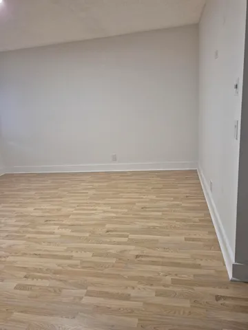 a view of a wooden bench in front of a building
