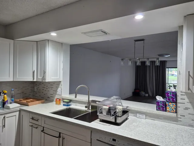 a kitchen with a sink and cabinets