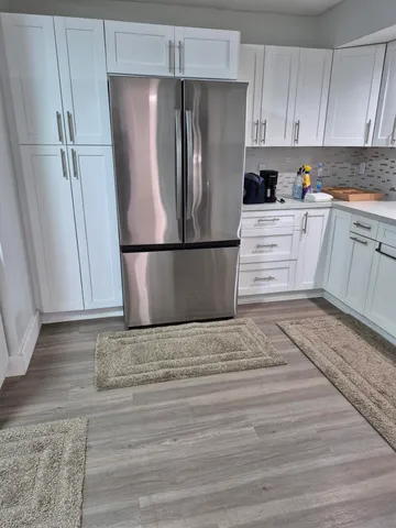 a kitchen with a refrigerator sink and cabinets