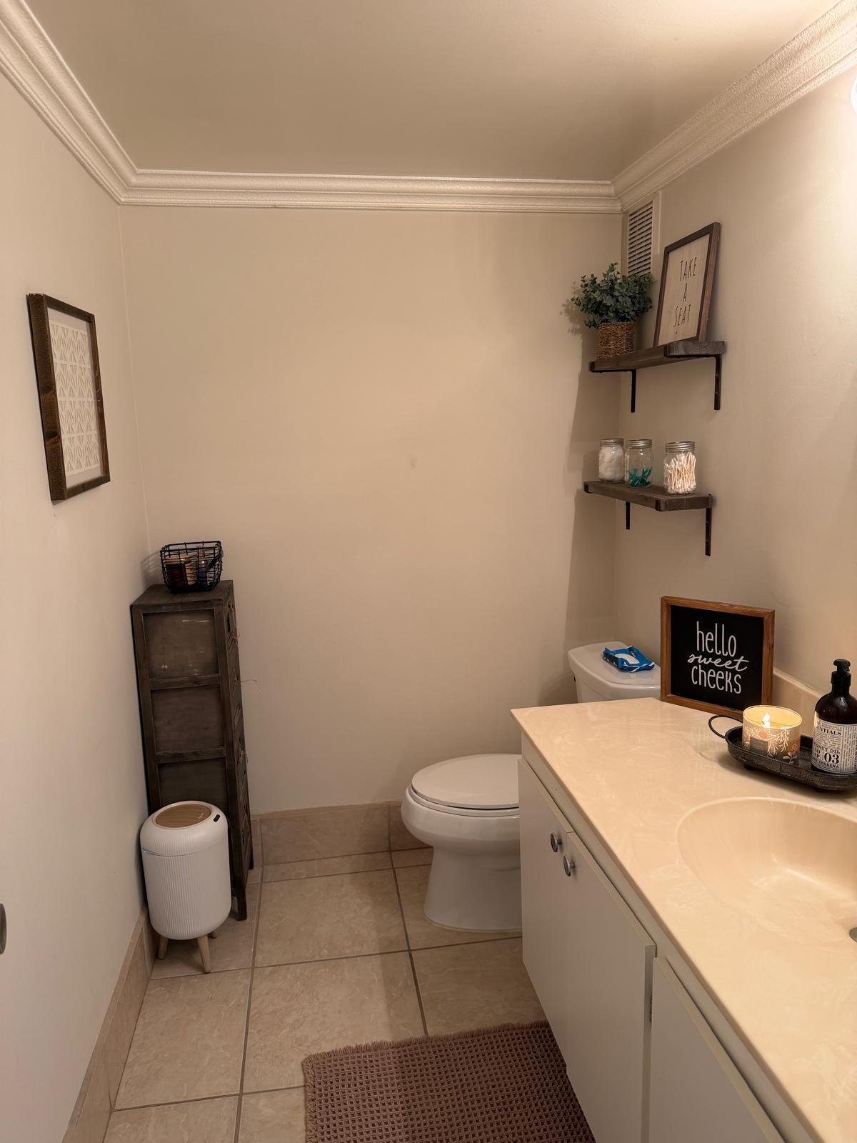711 North Pine Island Road, Unit 104 Plantation, FL 33324 - Photo 6 of 9 a bathroom with a toilet and a mirror