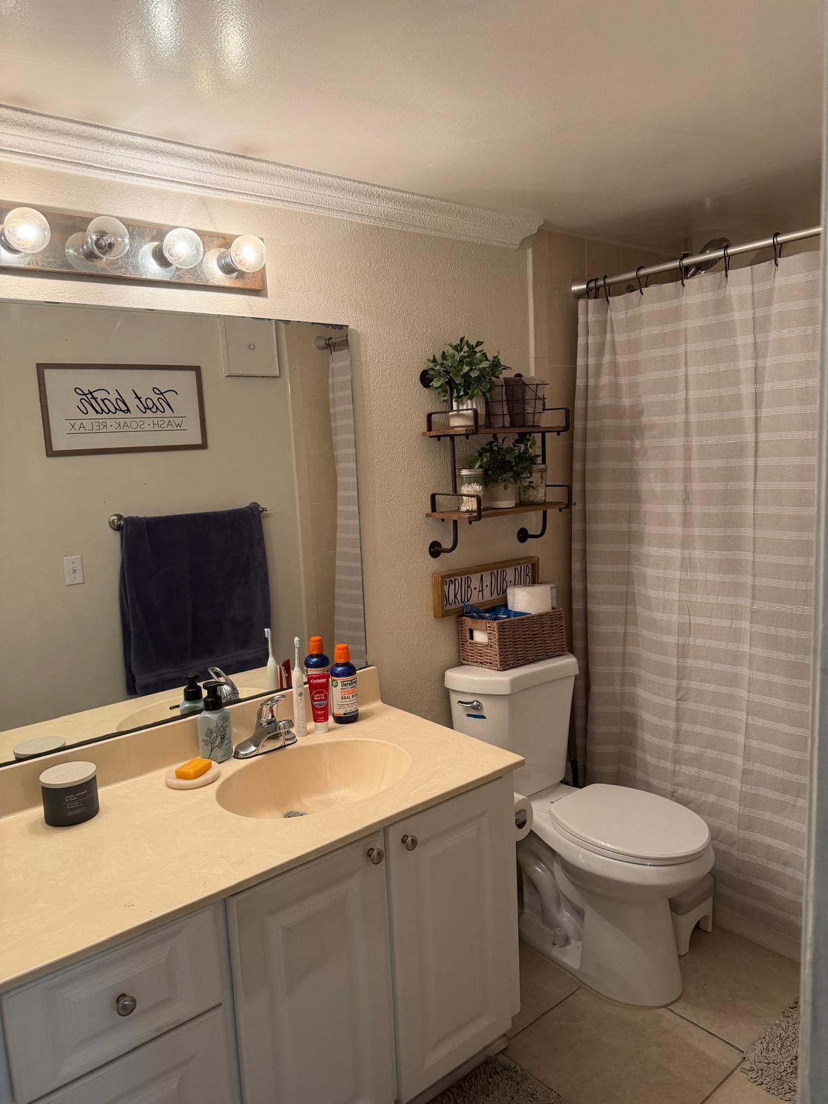 711 North Pine Island Road, Unit 104 Plantation, FL 33324 - Photo 7 of 9 a bathroom with a sink a toilet and shower