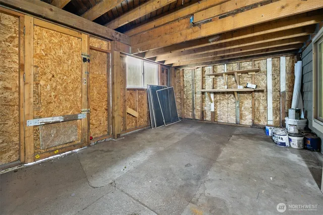 a view of house with a small yard and a large tree